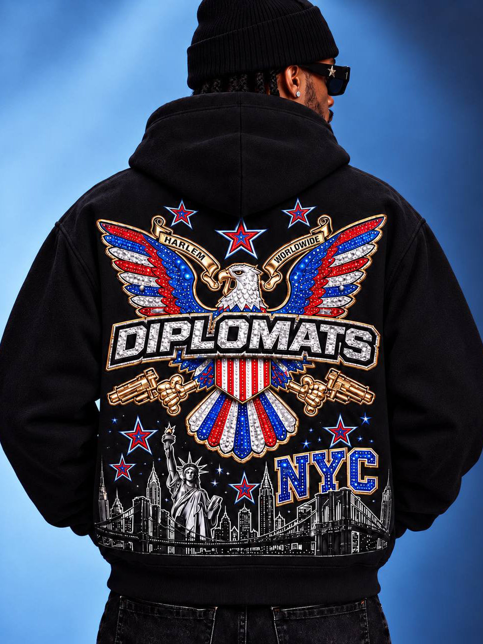 Man wearing black Diplomats iced eagle crest zip-up hoodie, back view with NYC skyline print