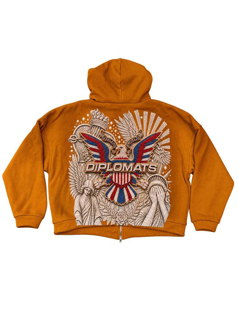 Timber orange Diplomats hoodie back with large iced-out Harlem World eagle crest and Diplomats wordmark over pale stonework artwork