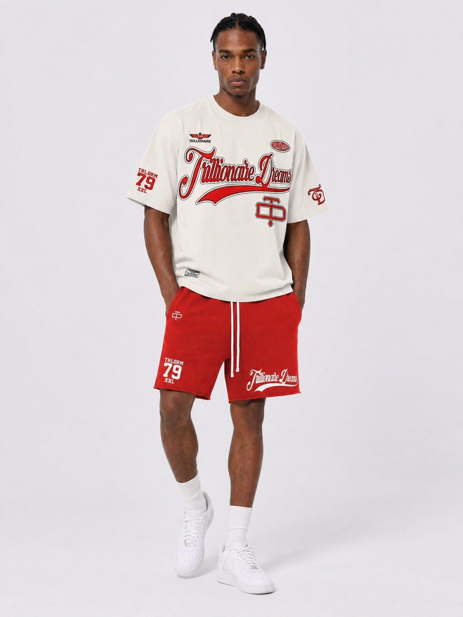 Cream boxy cropped graphic t-shirt with red Trillionaire Dreams varsity script logo on front and oversized TD Champions emblem on back