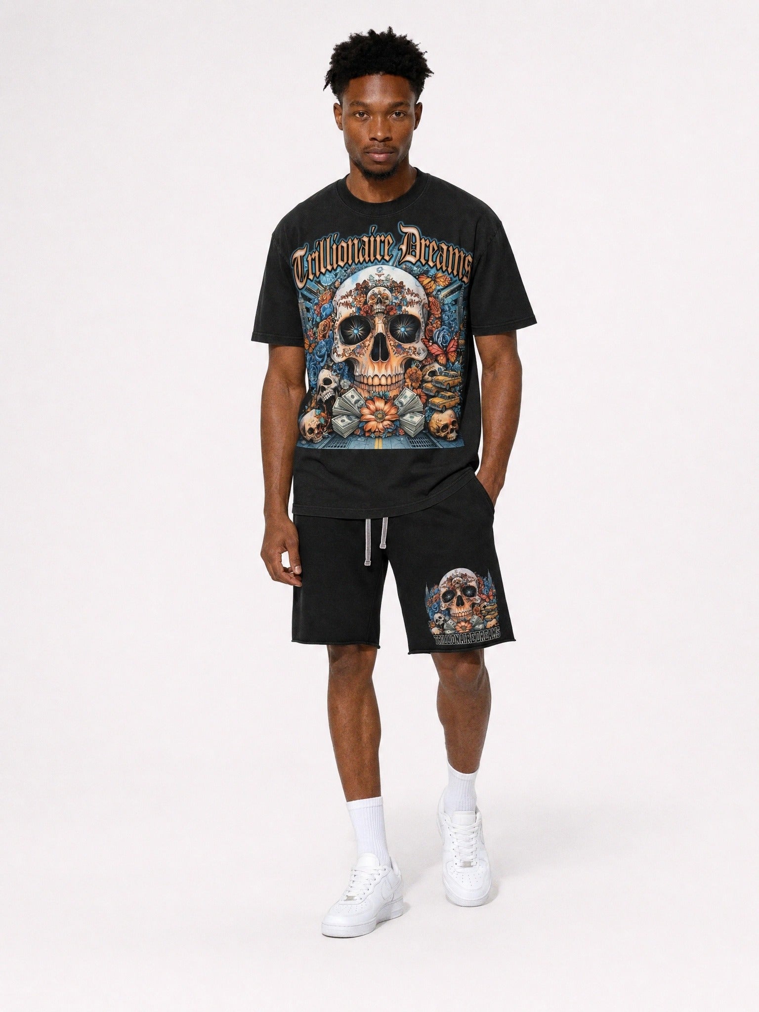 "Man wearing black Trillionaire Dreams Floral Skull matching tee and shorts set with gothic logo and NYC skull graphic"